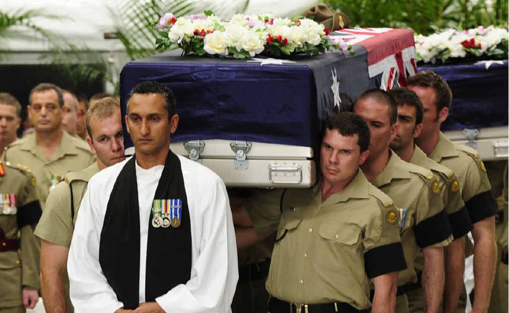Padre Isaac Kahn leads the Bearer Parties carrying the caskets of the fallen soldiers. Padre Isaac Kahn leads the Bearer Parties carrying the caskets of the fallen soldiers.